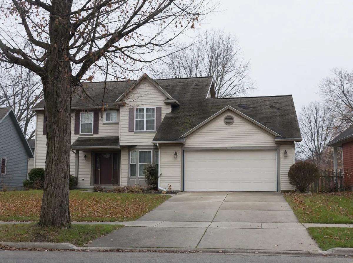 Before: worn asphalt shingle roof with moss and missing shingles on a home in Portage, Michigan
